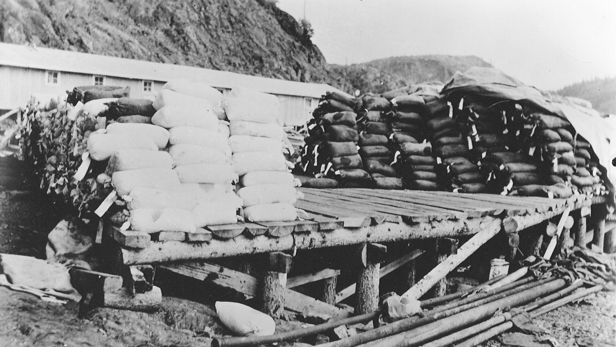 At the Port Radium dock, sacks of uranium concentrate await shipment to the Port Hope refinery. NWT