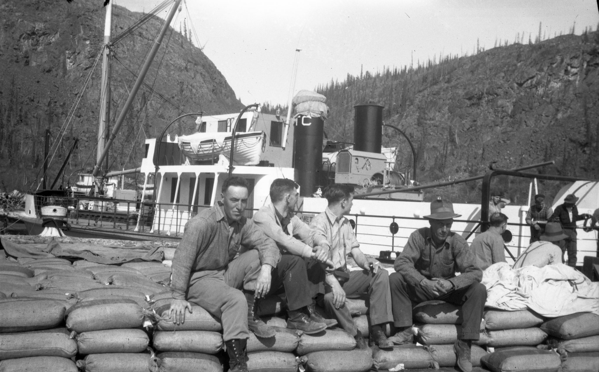 Dockside at Port Radium. Uranium concentrate waiting to be loaded on the lake boat for shipment to the Port Hope Eldorado refinery. 