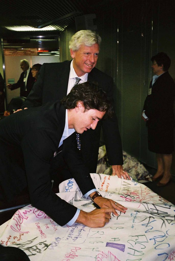 MP Justin Trudeau and Mayor David Miller sign a 36-foot Peace Day Canada banner minutes before the 25th anniversary of the Peace Garden in 2009.