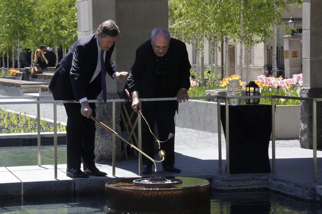 Mayor John Tory rededicated the Peace Garden as a memorial to the atomic bombing of Hiroshima and Nagasaki and lit the peace flame with Father Massey Lombardi.